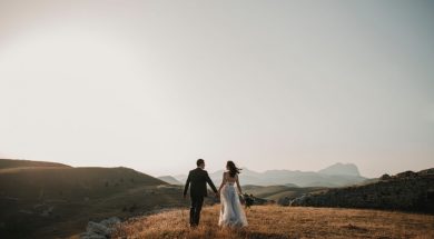 married-couple-walking-in-the-distance-on-hills-2.jpg