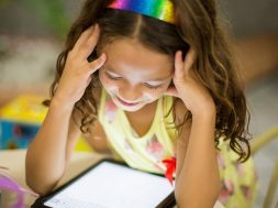 young-girl-smiling-at-an-iPad-2.jpg
