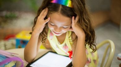young-girl-smiling-at-an-iPad-2.jpg