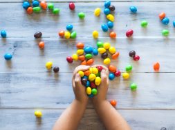 kid-holding-coloured-candy-2.jpg