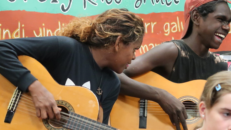 indigenous australians playing guitars