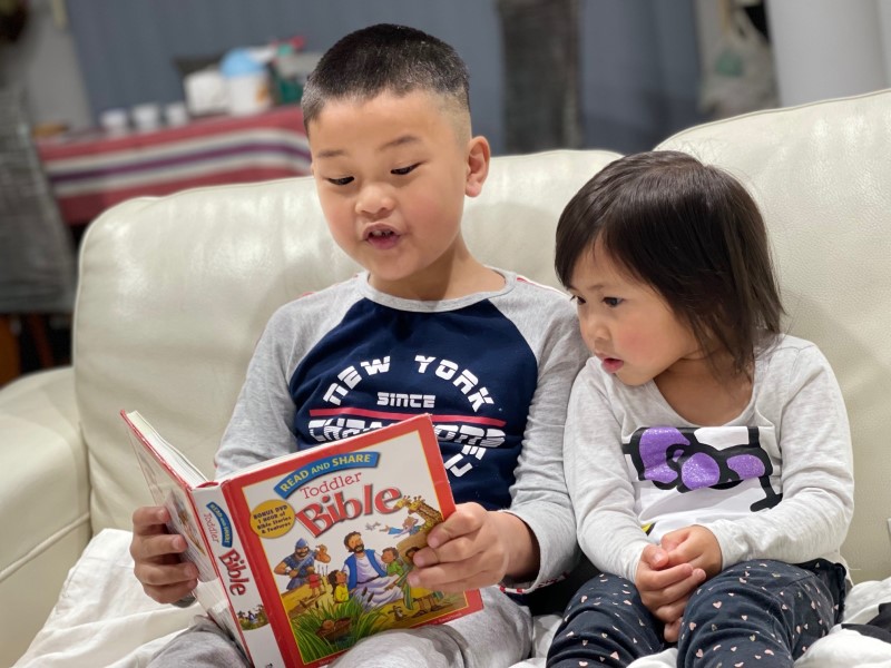 Young Siblings reading the Toddler Bible together