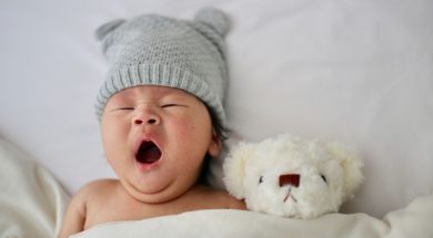 Baby-yawning-next-to-teddy-bear.jpg
