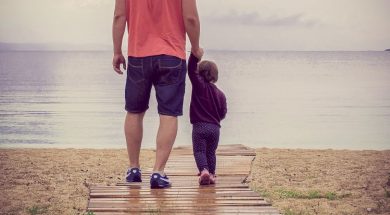 Father-and-daughter-walking-at-beach.jpg