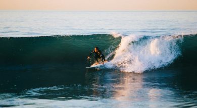 Man-surfing-by-Austin-Neill-Unsplash.jpg